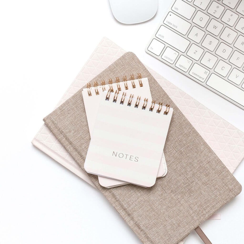 Pile of Notebooks - Getting Organised - Why You Should Hire a Virtual Assistant by Wildflower in Holmfirth