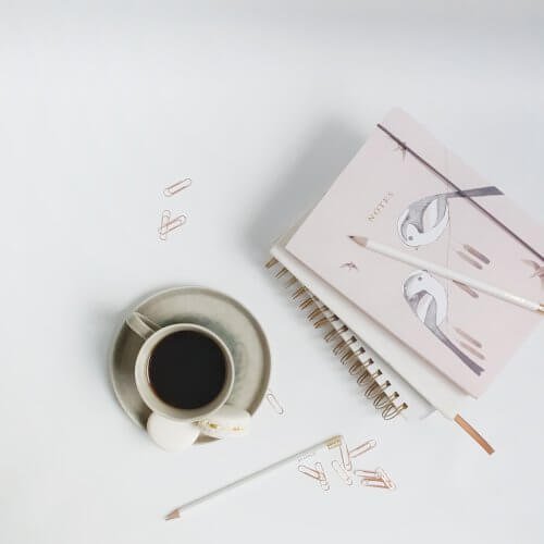 Pink Notebooks and Black Coffee Photo by Wildflower Virtual Assistant Services